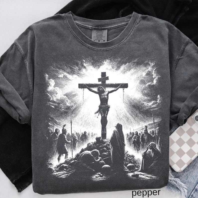 May include: Pepper-colored crew neck sweatshirt featuring a detailed black and white graphic of the crucifixion of Jesus. The design includes a cross, figures, and a dramatic sky. The word "pepper" is printed at the bottom.