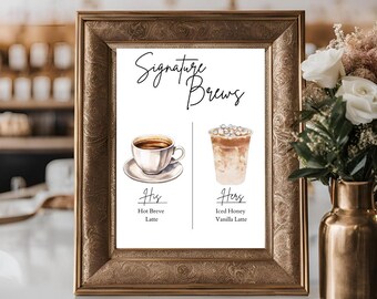 Könnte beinhalten: Ein Schild mit dem Text "Signature Brews" in schwarzer Schreibschrift. Das Schild zeigt zwei Aquarell-Illustrationen von Getränken: einen heißen Kaffee in einer weißen Tasse und einen kalten Eiskaffee in einem durchsichtigen Glas mit Strohhalm. Der Text "His" befindet sich unter der Kaffeetasse mit den Worten "Hot Breve Latte" darunter. Der Text "Hers" befindet sich unter dem Eiskaffee mit den Worten "Iced Honey Vanilla Latte" darunter.