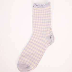 May include: A pair of light purple and white gingham socks with a frilly top.