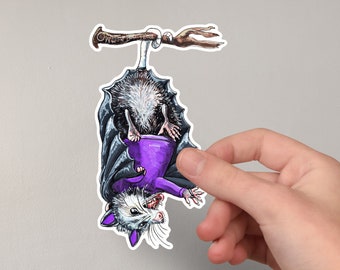 Opossum in Bat Costume Hanging Upside Down by Tail Vinyl Sticker  4" Decal