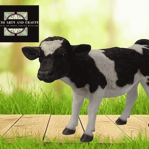 May include: A black and white calf figurine with a textured coat and dark hooves. The top left corner features a black square logo with the text NORTH ARTS AND CRAFTS and a stylized geometric design in white, teal, and tan colors.
