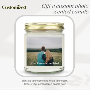 May include: A clear glass jar candle with a gold lid. The candle has a personalized label with a photo of a couple standing in a field. The text on the label reads "Your Personalized label".