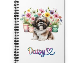 May include: A white spiral notebook with a colorful illustration of a Shih Tzu puppy sitting in a bed of flowers. The flowers are in colorful pots. The text "Daisy" is written in rainbow colors with a heart symbol.