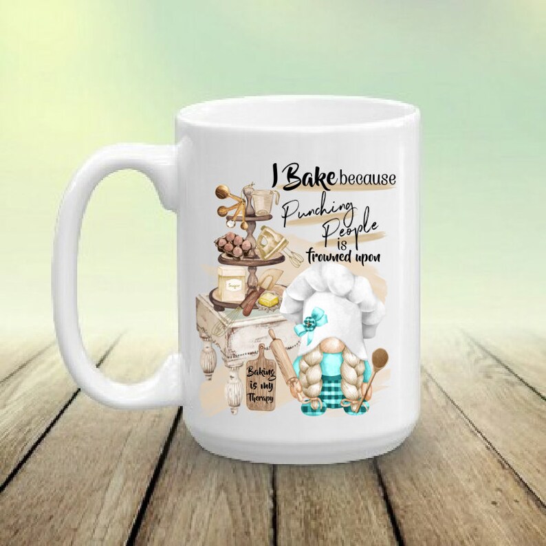 May include: White ceramic mug with a humorous baking-themed design. It features the text "I Bake because Punching People is frowned upon" and a gnome chef. The mug also includes the phrase "Baking is my therapy."