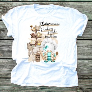 May include: White t-shirt with a baking-themed graphic. The design features a gnome chef, baking tools, and the text "I Bake because punching people is frowned upon. Baking is my therapy."