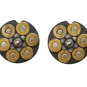 May include: Two black revolver cylinders with six gold-colored bullets each. The bullets are labeled "38 SPECIAL".