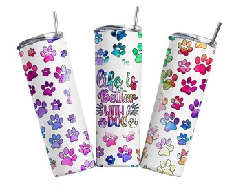 May include: Three stainless steel tumblers with lids and straws. The tumblers are white with a colorful paw print pattern and the text "Life is better with a dog".