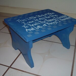 May include: A blue wooden step stool with white lettering that reads "This Little Stool of Mine I use It All The Time To Reach The Things I Could And Lots of Things I Shouldn't".