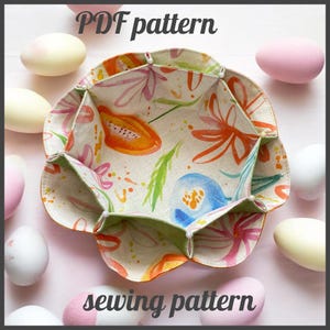 May include: A fabric bowl with a floral and papaya design. The bowl is surrounded by pastel-coloured eggs. The text "PDF pattern" and "sewing pattern" are at the top and bottom of the image.