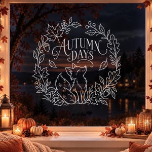 Puede incluir: Un adhesivo de ventana de arte lineal blanco que presenta un zorro sentado dentro de una corona circular de hojas de arce, hojas de roble, bellotas y setas. El texto AUTUMN DAYS está escrito en una fuente decorativa en el centro.