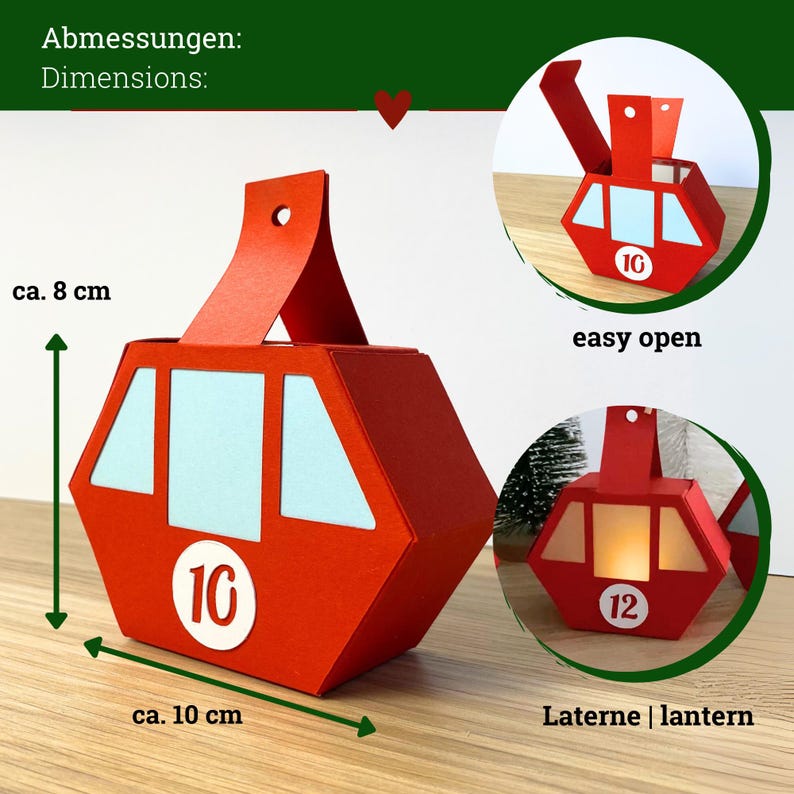 May include: A red paper cable car box with light blue windows and a white circular tag featuring the number 10. The box measures approximately 8 cm in height and 10 cm in width. Additional circular insets show the box opening and functioning as a lantern with the number 12.