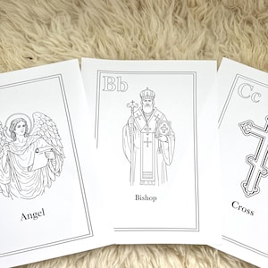 May include: Three black and white illustrations on white paper. The illustrations feature an angel, a bishop, and a cross, with the words "Angel", "Bishop", and "Cross" printed below each image. The letter "Bb" is printed above the bishop illustration.