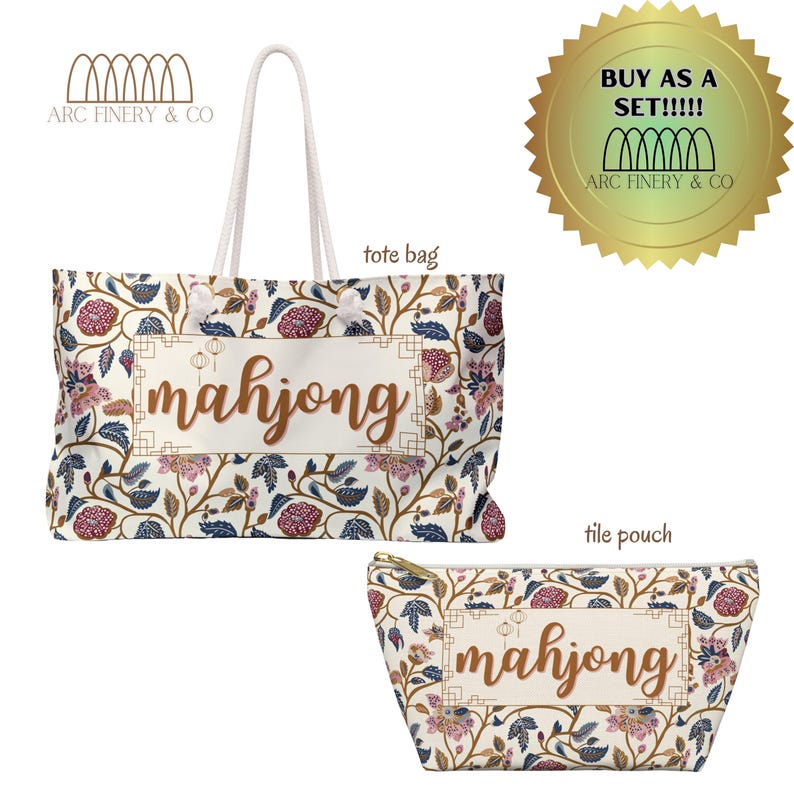May include: A white tote bag and a matching cosmetic bag with a floral pattern and the word "mahjong" in gold lettering. The tote bag has two rope handles. The cosmetic bag has a zipper closure.