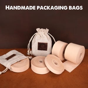May include: A set of four handmade leather packaging bags. The bags are made of natural leather and have a light brown color. The bags are perfect for packaging small items, such as jewelry, cosmetics, or gifts.