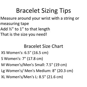 May include: A chart with instructions on how to measure your wrist for a bracelet. It includes a size chart with measurements in inches and centimetres for XS, S, M, Lg, and XL sizes.