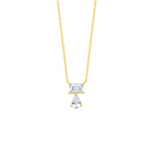 May include: A gold chain necklace featuring a pendant with a horizontal emerald-cut clear gemstone positioned above a dangling pear-shaped clear gemstone. The metal is yellow gold, and the stones are set in a simple, clean, and reflective design.