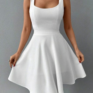May include: A white sleeveless dress with a square neckline and a fitted bodice. The skirt is a-line and falls to just above the knee.