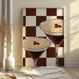 May include: Two brown and white coffee cocktails with coffee beans on top, set against a brown and white checkered background.