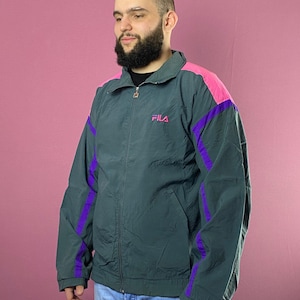 May include: A dark green jacket with purple and pink accents. The jacket has a zipper closure and a logo that says "FILA" on the left chest.
