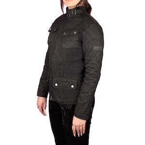May include: Black quilted jacket with a stand-up collar and multiple pockets. The jacket features a diamond pattern on the sleeves and body, with a vertical ribbed design on the front. A small logo patch is visible on the upper arm.