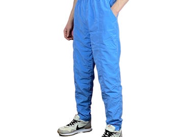 May include: Light blue nylon track pants with a drawstring waist and side pockets.