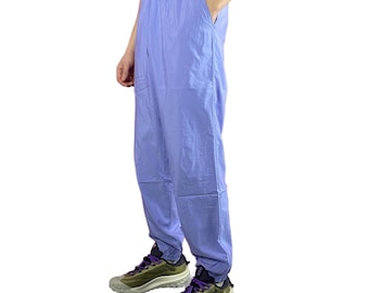 May include: A pair of light blue pants with a drawstring waist. The pants are made of a lightweight fabric and have a relaxed fit.