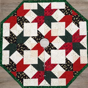 May include: An octagonal Christmas tree skirt featuring a patchwork design of red, dark green, black, and cream fabric squares. The pattern includes star shapes and holly leaf motifs with gold accents. It has a central circular cutout and white buttons.