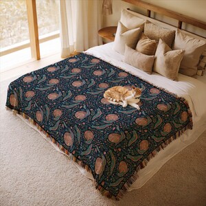 Cozy bed with patterned throw blanket, featuring a cat sleeping.