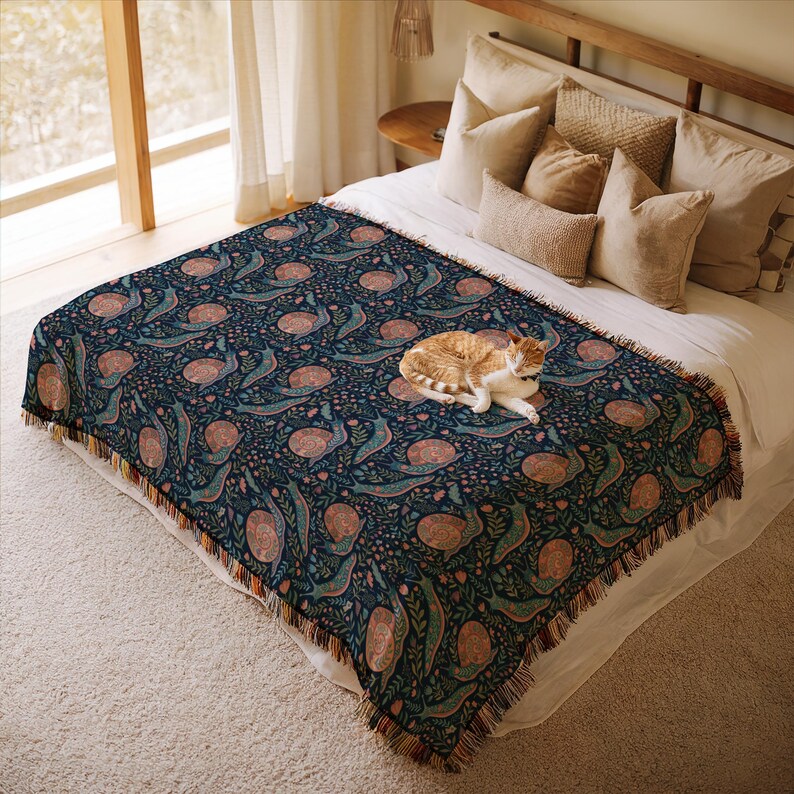 Cozy bed with patterned throw blanket, featuring a cat sleeping.