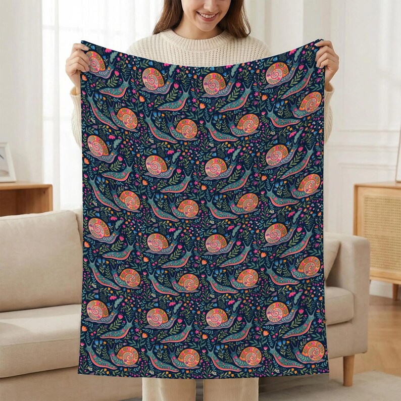 Dark blue blanket with a colorful snail and floral pattern.