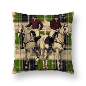 May include: Throw pillow featuring an illustration of two riders on white horses. The riders wear riding attire and hats. The background is a green and black plaid pattern. The pillow has a distressed, vintage look.