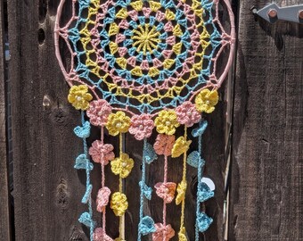 Crochet Dream Catcher with Flowers in Yellow, Turquoise, and Pink with small pearls on a 12" ring.  Free Shipping