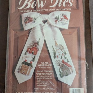 May include: A Bow Ties cross stitch kit titled Winter Wonderland by Michael A. LeClair. The package contains a 4 inch by 58 inch prefinished ribbon, #14 Aida, cotton floss, a needle, and instructions to create an 11 inch by 17 inch tied bow.