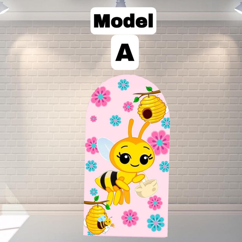 May include: A pink backdrop with a cartoon bee design. The bee is yellow and black, holding a basket, with a smiling face. The backdrop also features flowers and beehives. The text "Model A" is at the top.