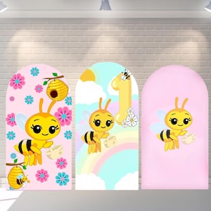 May include: Three arched panels with bee-themed illustrations. The panels feature a cartoon bee with a smiling face, wings, and a striped body. The backgrounds are pink, white, and a rainbow design, with flowers, a beehive, and the number 1.