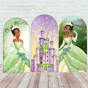 May include: Three arched display panels featuring a character in a green gown with a tiara on the left and right panels, and a purple and green castle with a sparkling background on the center panel, all set against a white brick wall.