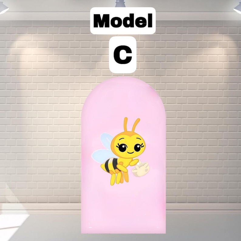 May include: A pink arched-shaped object with a cartoon bee illustration. The bee is yellow and black with blue wings, holding a small white object. Above the object are the words "Model C" in black text.