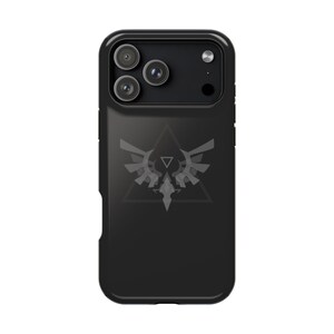 May include: Black phone case with a triple-lens camera array. The case features a stylized, light gray emblem of a bird-like creature within a triangle. The case is designed to protect the phone from damage.