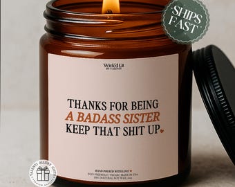 May include: A lit soy wax candle in a brown glass jar with a black lid. The label reads "THANKS FOR BEING A BADASS SISTER KEEP THAT SHIT UP." The candle is 4 oz and is hand-poured in the USA.