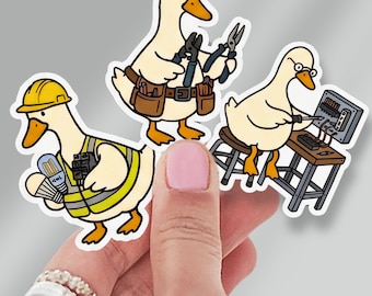 May include: Three die-cut stickers featuring cartoon ducks performing electrical work. One duck wears a yellow hard hat and high-visibility vest, another wears a brown tool belt holding pliers, and the third sits on a stool using a screwdriver on a panel.