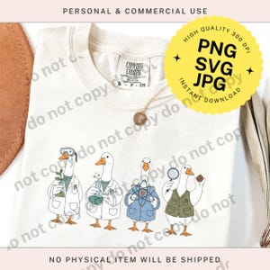 May include: Cream-colored t-shirt featuring a whimsical illustration of four geese dressed as scientists. Each goose wears a lab coat or jacket and holds scientific tools. The shirt also has the text "Comfort Colors" and "S-P-CH".