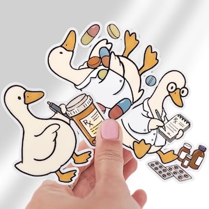May include: Three die-cut stickers featuring cartoon ducks in medical roles. One duck wears a white coat and writes on a notepad with an Rx symbol. Another holds an orange prescription bottle. A third duck is surrounded by colorful pills and capsules.