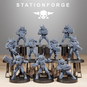 May include: A group of ten gray plastic miniature figures, each holding a weapon, standing on black bases. The figures are arranged in a staggered formation, with the front row slightly lower than the back row. The figures are all wearing helmets and armor, and they appear to be soldiers or space marines. The figures are all facing forward, and they are all looking straight ahead. The figures are all standing on a wooden surface. The figures are all painted in a gray color, and they all have a matte finish. The figures are all about 2 inches tall.