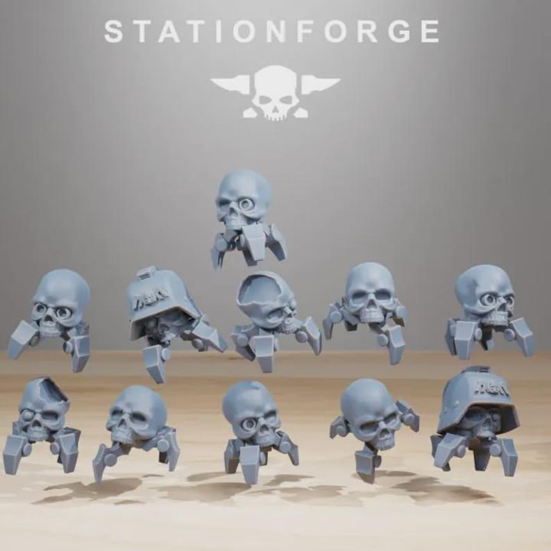 May include: A collection of gray skull-shaped miniatures with robotic legs. Some skulls have helmets. The word "STATIONFORGE" is at the top, along with a skull and crossbones logo. These miniatures are likely for tabletop gaming or model building.