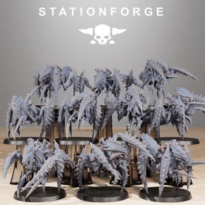 May include: A collection of 15 grey, detailed, plastic, miniature, sci-fi, insect-like creatures with multiple legs and wings. The creatures are posed on black bases and arranged in rows on a wooden surface. The image includes the text "STATIONFORGE" at the top.