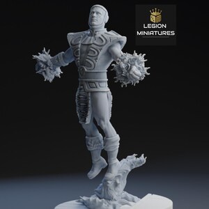 May include: A gray miniature figure of a male character in a dynamic pose, with detailed armor and energy-like spheres emanating from his arms. The figure is mounted on a textured base, with the "LEGION MINIATURES" logo in the top right corner.