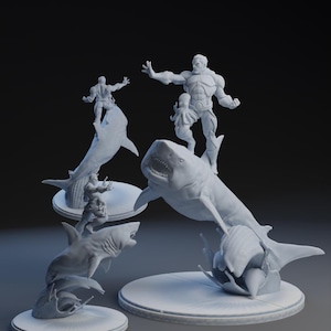 May include: A collection of gray sculptures depicting figures riding sharks. The figures are in dynamic poses, with one figure appearing to be fighting an octopus. The sculptures are on round, white bases, creating a dramatic scene.