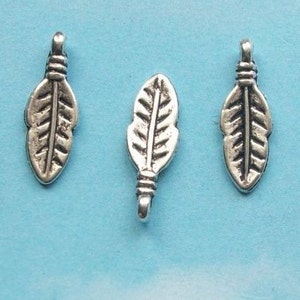 May include: Three silver feather charms with a detailed design. The charms have a loop at the top for attaching to jewelry.