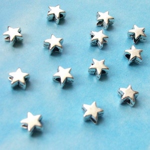 100 very tiny star beads, smooth/plain, shiny silver tone, 5mm