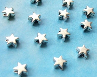 100 very tiny star beads, smooth/plain, shiny silver tone, 5mm